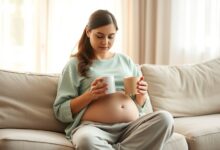 Woman experiencing 9 weeks pregnant symptoms resting with ginger tea at home