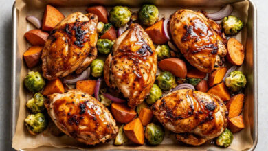 Healthy fall harvest sheet pan dinner with roasted chicken, sweet potatoes, and Brussels sprouts